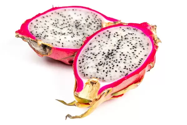 Halves of cactus fruits - pitahaya on white