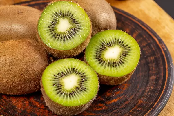 Halves of fresh kiwi fruit and whole, close-up