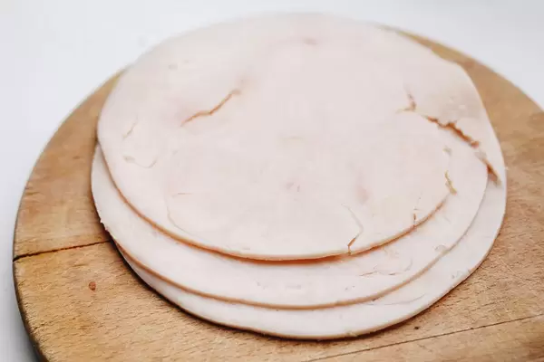 Ham slices on wooden board. Close up