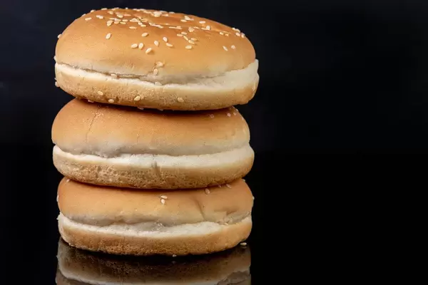 Hamburger Buns above black reflective background with copy space (Flip 2019)