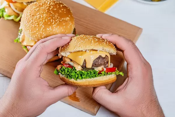 hamburger in the hands of a man