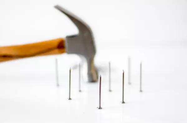 hammer with Nails on a White Background close-up