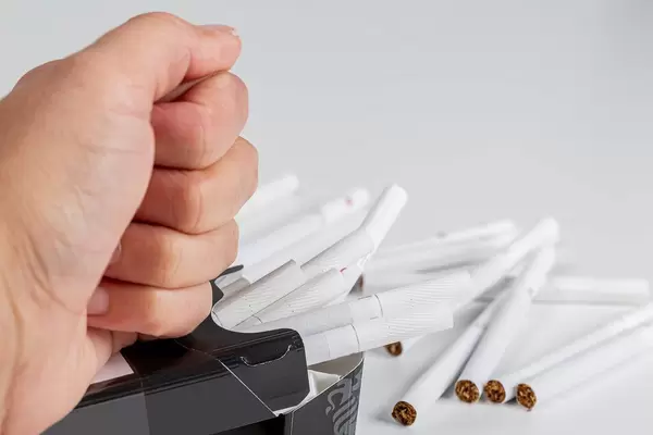 Hand breaks a pack of cigarettes. Quit smoking concept