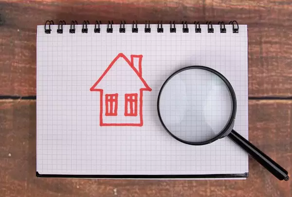 Hand drawn house with magnifying glass