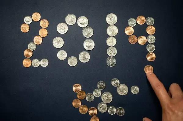 Hand forms the date 2019 with coins
