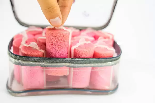 Hand grabbing a foam hair curler