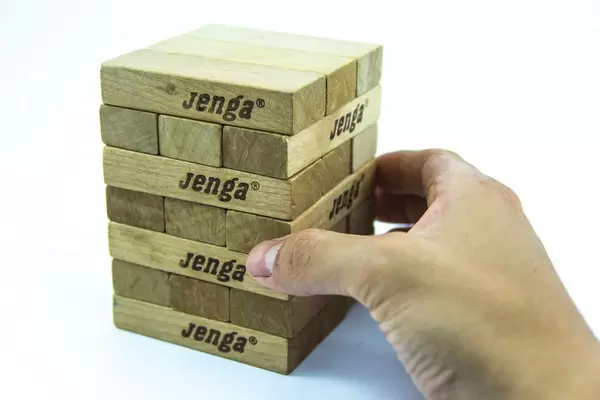 Hand Grabbing a Jenga Block