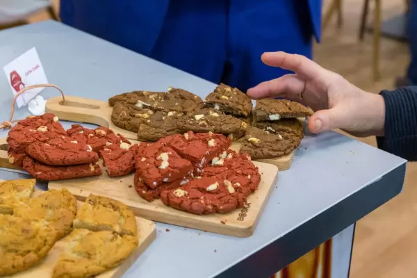 Hand grabs coffee cookies in different colors