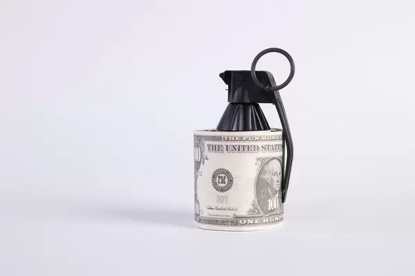 Hand grenade and Dollar banknote on white background