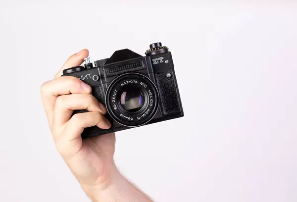 Hand holding an old vintage film camera