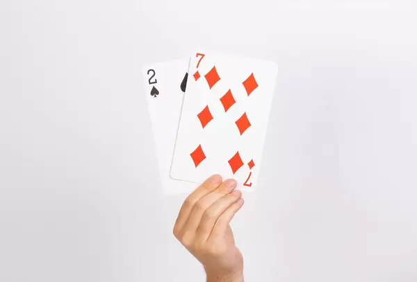 Hand holding deuce and seven playing cards.jpg