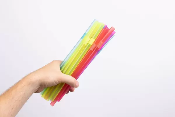 Hand holding drinking straws