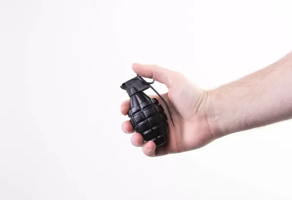 Hand holding hand grenade