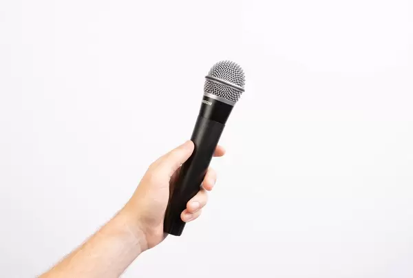 Hand holding microphone