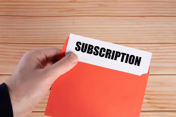 Hand holding open envelope with Subscription text