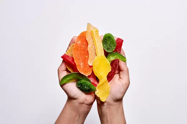 Hand holding pile of sweet dried fruits