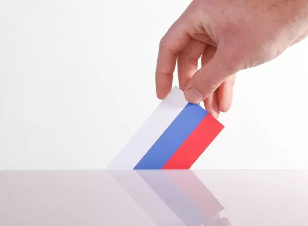 Hand holding Russian flag. Russian election concept