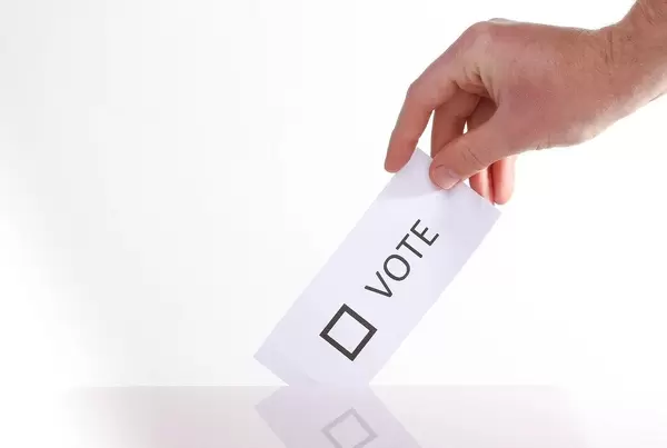 Hand holding voting ticket