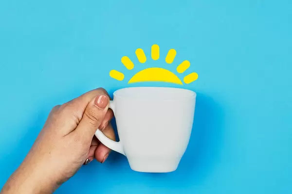 Hand holds morning coffee