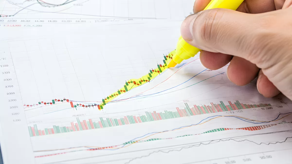 Hand markiert Aufwärtstrend im Kerzenchart mit Textmarker