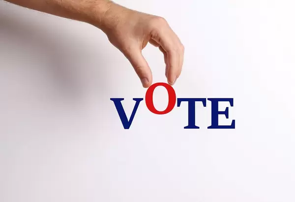 Hand pick up 'O' from Vote text