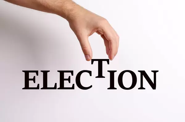 Hand pick up 'T' from Election text