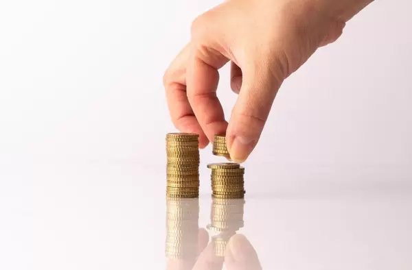 Hand putting coins on stack (Flip 2019)