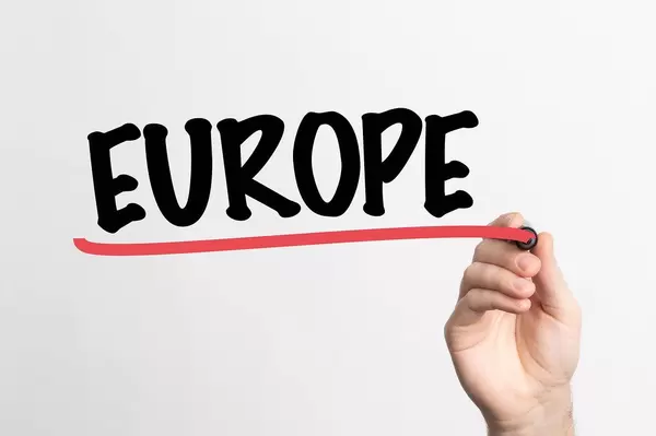 Hand schreibt das Wort "Europa" auf ein Whiteboard