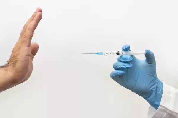 Hand showing stop hand gesture to doctor