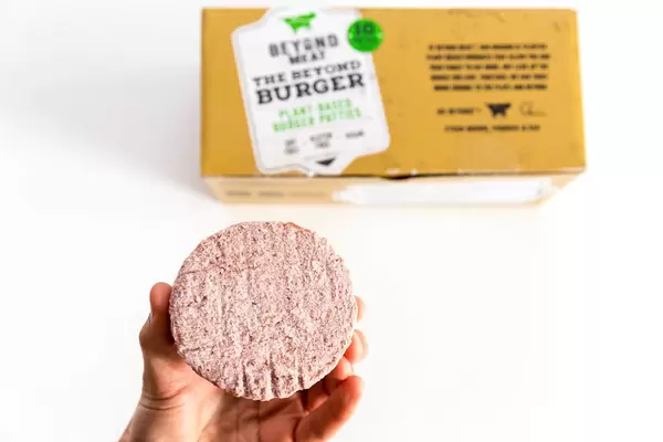 Hand shows Beyond Meat Patty, the vegan alternative of burger meat for a more sustainable world