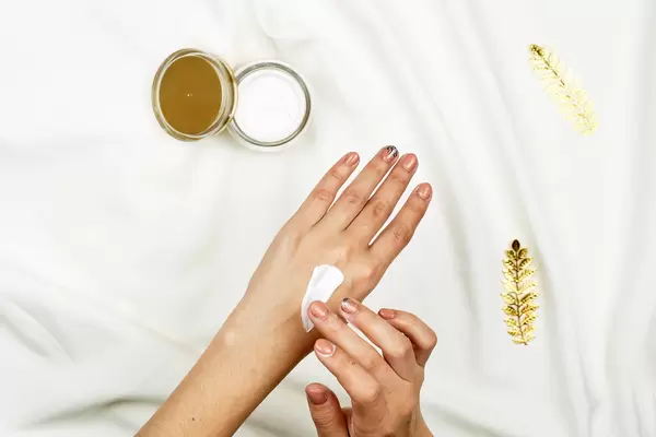 Hand skin care. Close-up of female hands applying cream
