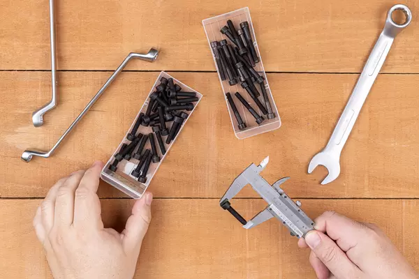 Hand tools and Inbus screws above wooden table