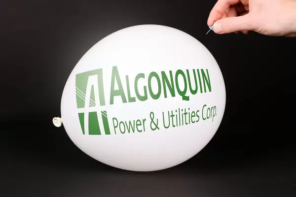 Hand uses a needle to burst a balloon with Algonquin Power & Utilities Corp. logo