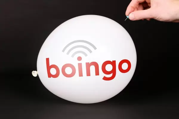 Hand uses a needle to burst a balloon with Boingo Wireless logo