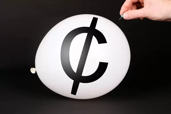 Hand uses a needle to burst a balloon with Cent symbol