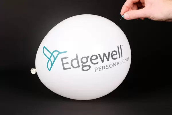 Hand uses a needle to burst a balloon with Edgewell logo