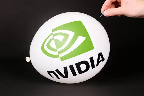 Hand uses a needle to burst a balloon with Nvidia logo