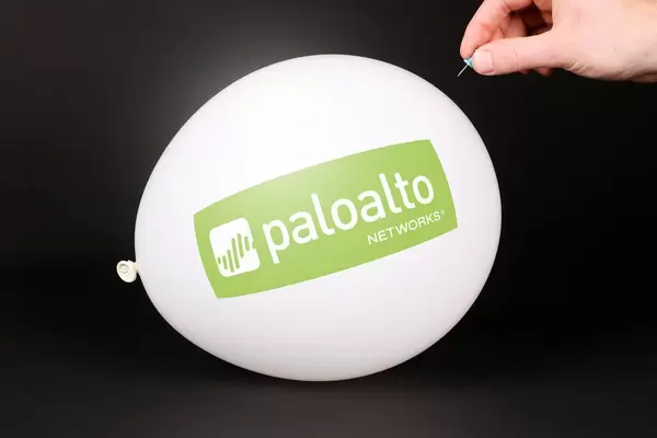 Hand uses a needle to burst a balloon with Palo Alto Networks logo