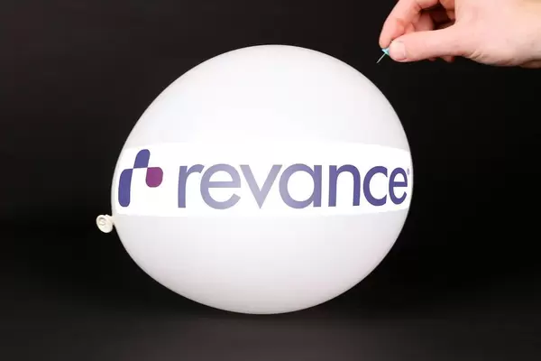 Hand uses a needle to burst a balloon with Revance logo