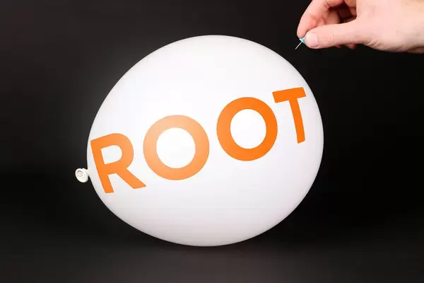 Hand uses a needle to burst a balloon with Root Insurance logo