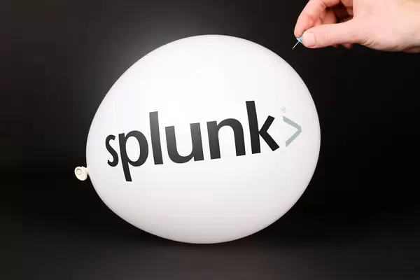Hand uses a needle to burst a balloon with Splunk logo