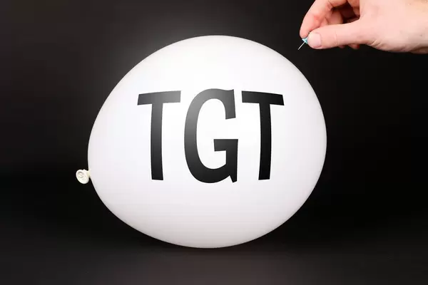 Hand uses a needle to burst a balloon with TGT text