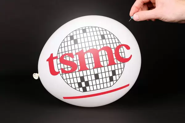 Hand uses a needle to burst a balloon with TSMC logo