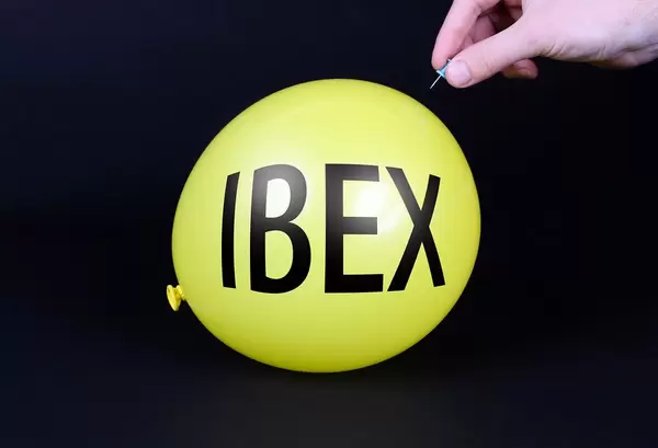 Hand uses a needle to burst a yellow balloon with IBEX text