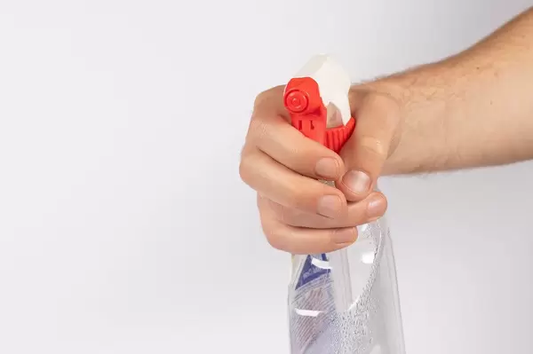 Hand with a cleaning product on white background (Flip 2019)