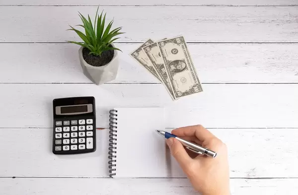 Hand with pen making notes