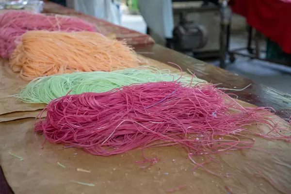 Handmade Noodles made from different Ingredients such as Sweet Potatoes on a Workshop Table at a Local Factory in Can Tho, Vietnam