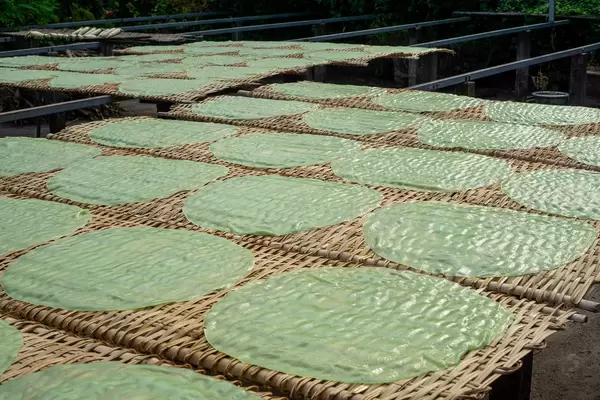 Handmade Rice Paper drying in the Sun on Bamboo Racks at a Rice Paper and Noodle Factory in the Mekong Delta in Vietnam