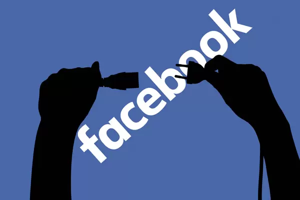 Hands connecting cables to net - Outage of Facebook has been fixed