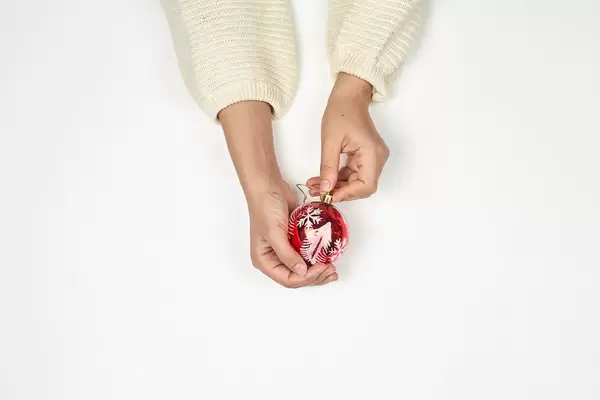 Hands holding Christmas ornament
